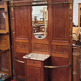Attractive French Burr Walnut Hallstand. It has a single drawer, cupboard, brass rods, umbrella storage and a marble shelf. It is in good original condition. Please see photos as they form part of the description.