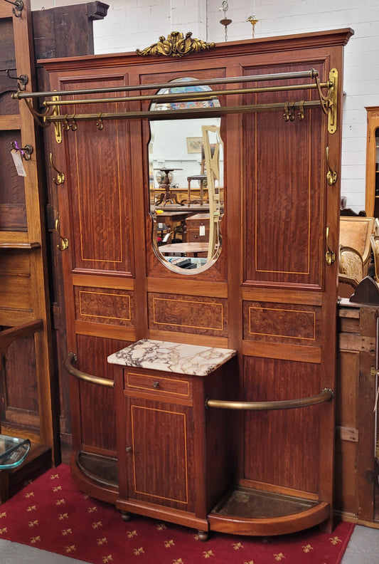 Attractive French Burr Walnut Hallstand. It has a single drawer, cupboard, brass rods, umbrella storage and a marble shelf. It is in good original condition. Please see photos as they form part of the description.