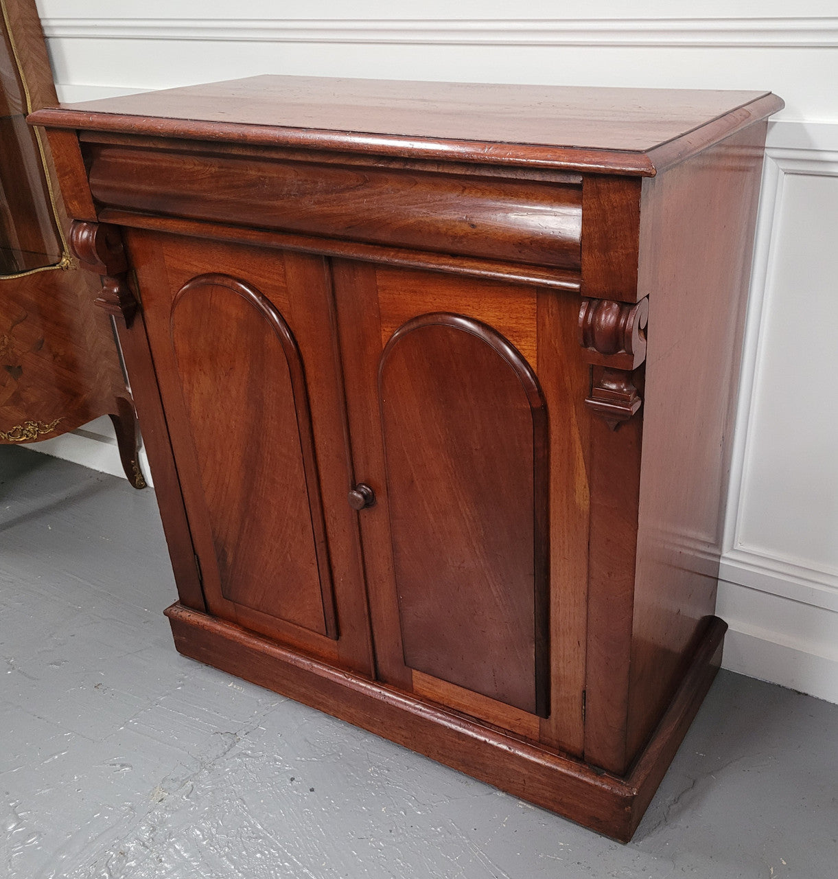 Cedar side cabinet with two doors one drawer and lovely door panels and corbels. It has been sourced locally and is in good original detailed condition.