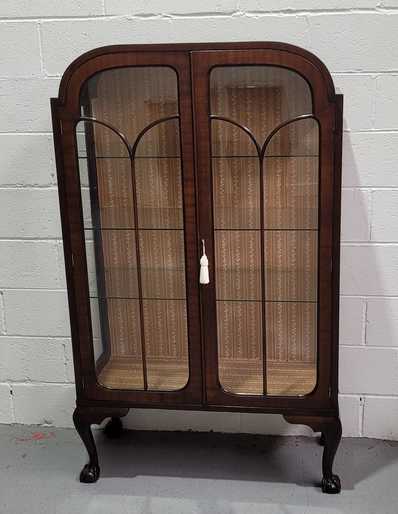 Chippendale style Walnut display cabinet of pleasing narrow portions. It is in good original condition and comes with three shelves.