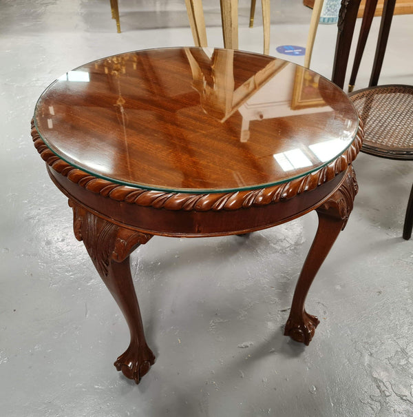 A beautiful round Mahogany Chippendale style coffee table with a glass top. In good original detailed condition.