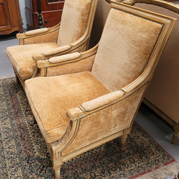 Pair of Louis XVI style painted arm chairs with carving & fluted legs. They have been sourced from France and the fabric is in good used original condition. Please view photos as they help form part of the description.