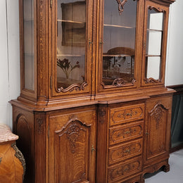 Impressive French Oak Louis 14th Style Display and Sideboard. It has 4 drawers, 2 bottom cupboards with 6 total shelves and 3 display doors with 3 shelves.  In good, detailed condition.