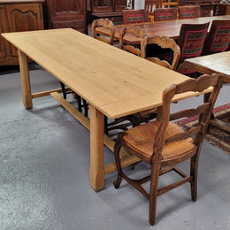 French raw Oak stretcher based refectory table. Features raw wood that could be used as is for a distressed look, or finished and waxed for a more refined look. Sourced from France and in good original condition.