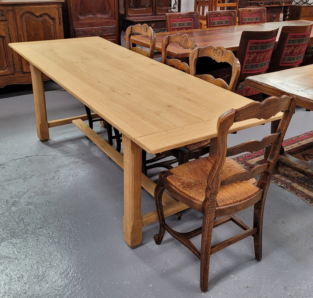 French raw Oak stretcher based refectory table. Features raw wood that could be used as is for a distressed look, or finished and waxed for a more refined look. Sourced from France and in good original condition.