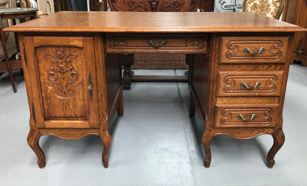 Beautifully carved French oak small desk with three drawers and a cupboard for all your storage needs. In good original condition. Great size for small spaces.