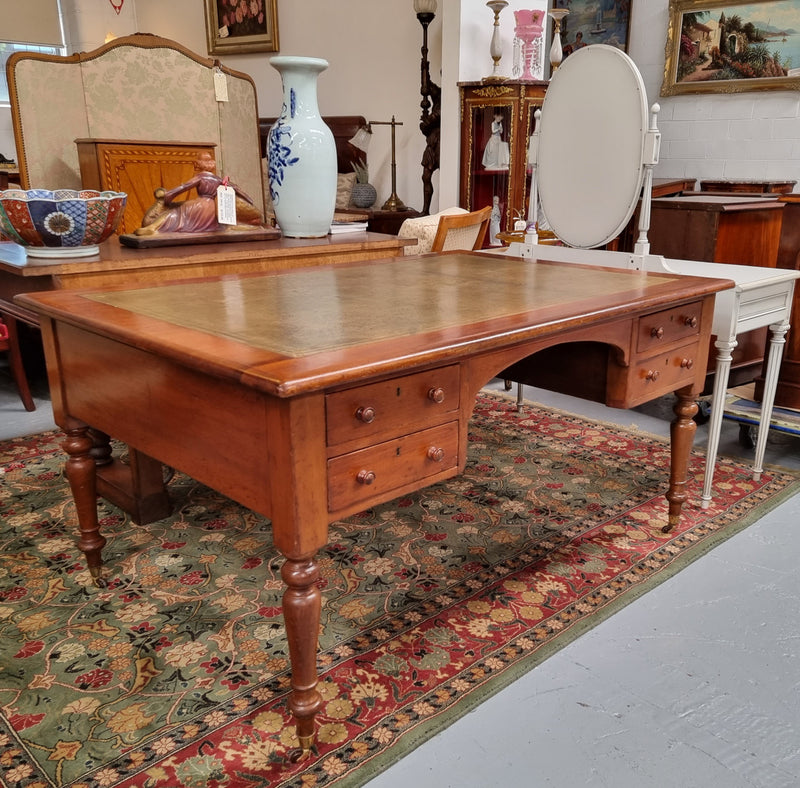 English Cedar full partners desk with attractive tooled leather top, four drawers either side and on caster wheels.  In good original detailed condition.