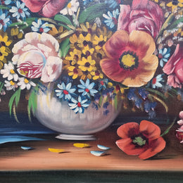 Sourced from France a stunning colorful floral oil painting on canvas. It is in a decorative gilt frame and is signed. It is in good original detailed condition.