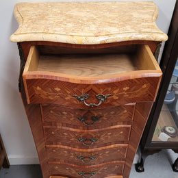 Stunning French seven drawer Kingwood and marquetry inlaid semainier with a beautiful marble top. In good original detailed condition.