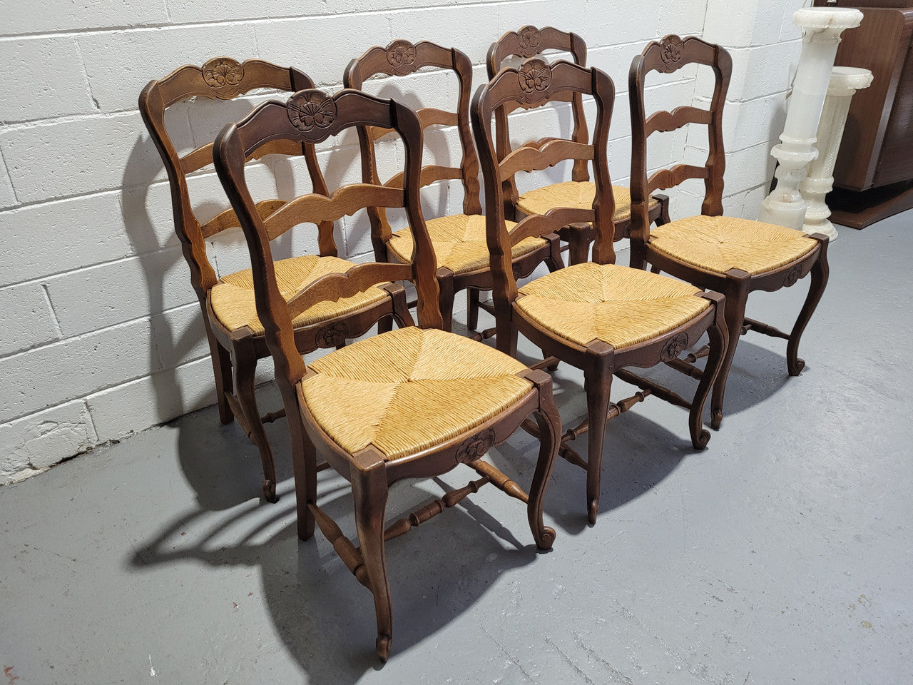 A stunning set of six French Louis XV Style oak dining chairs with rush seats in good original condition. All chairs have been detailed and re-glued where needed.