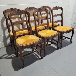 A set of 6 French Louis XV style oak dining chairs with rush seats in good original condition. All chairs have been detailed and re-glued where needed.
