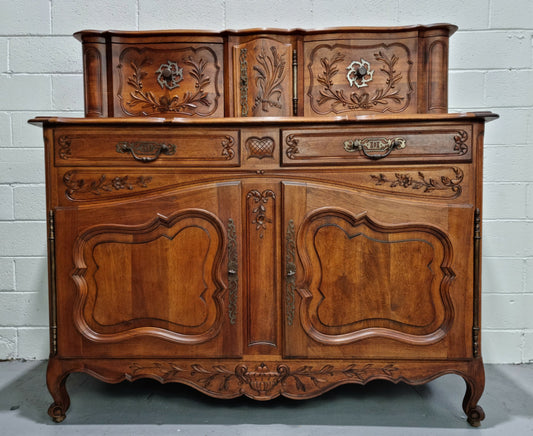 Stunning 19th Century French Walnut Buffet à Glissant from Provence, France. This is an exceptional charming piece and very functional with plenty of storage space, two large cupboards at the bottom, two drawers in the middle and two sliding doors either side at the top and finished off with a small central cupboard. In good original detailed condition.