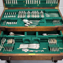 English Oak beautifully fitted cutlery table with a lift up top and drawer. Contains extensive silver plate part cutlery service by Elkington. In good original condition.