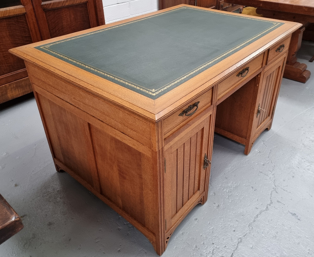 French Oak Art Deco full partners desk with leather top. Plenty of storage with both sides having three drawers at the top and two cupboards on both sides, one side has a filing section with three internal drawers and the other has a shelf on one side with three internal drawers as well. In good original detailed condition.