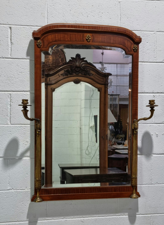 Decorative late 19th Century mahogany French wall mirror with brass swivel candle holders and brass detail. In good original detailed condition.
