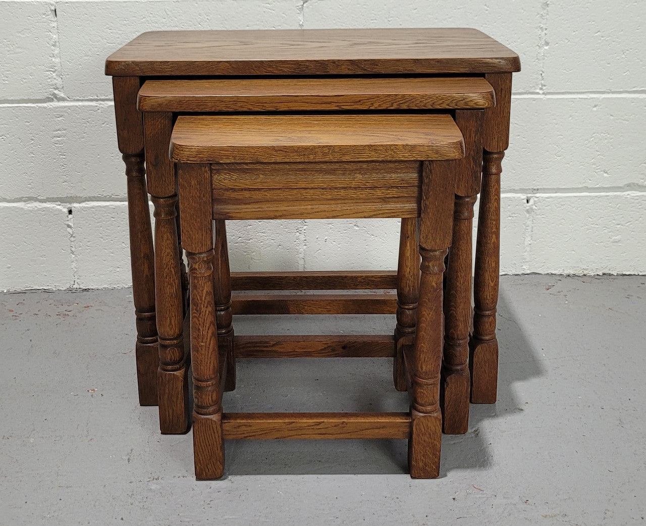 Lovely tudor oak style three nest tables. Circa 1950, In good original detailed condition.