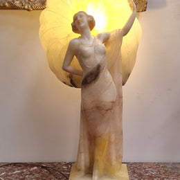 Monumental Art Deco alabaster and marble figural lamp modelled as a seductively dressed semi naked woman. In subtlety coloured diaphanous robes with a large clam shell light backdrop. Italian circa 1920's signed to base. This is a world class example of a true Art Deco sculpture lamp. It is in good original detailed condition, please view photos as they help form part of the description.