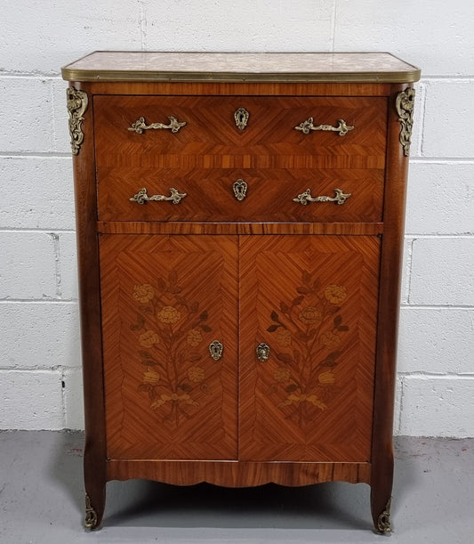 Lovely French Louis XV style Mahogany marquetry inlaid two door side cabinet. It has a beautiful coloured brass bound marble top in good original detailed condition.