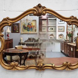 French Louis XV style wood carved and gilded mirror. Mirror is original and showing signs of age. It has been sourced from France and  in good original condition.