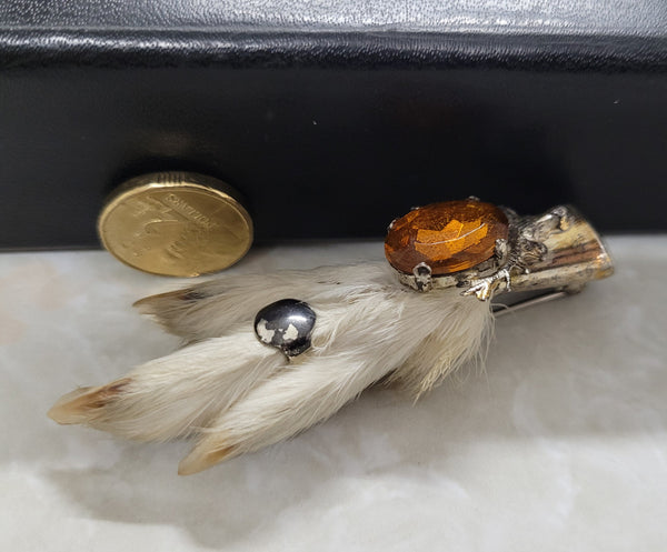 Scottish Grouse foot with Amber coloured glass. In good original condition, please view photos as they help form part of the description.