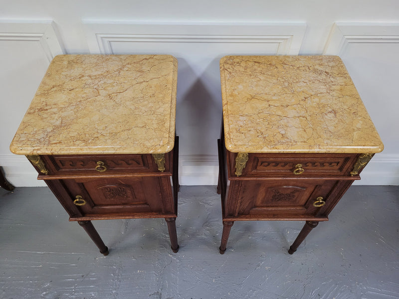 French Oak pair of Louis 16th style marble top bedsides with stunning bronze mounts. They have been sourced from France and are in good original detailed condition.