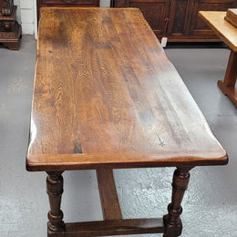 Rustic French Oak stretcher based farmhouse dining table that comfortably seats 6-8 people. It has been sourced from France and is in good original condition.