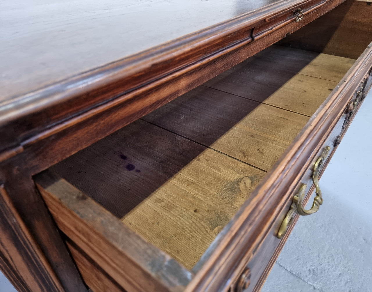 Early 19th century carved Oak three-drawer commode. Beautiful handles and has a small hidden drawer at the top. In good original detailed condition. Please note keys are not included.