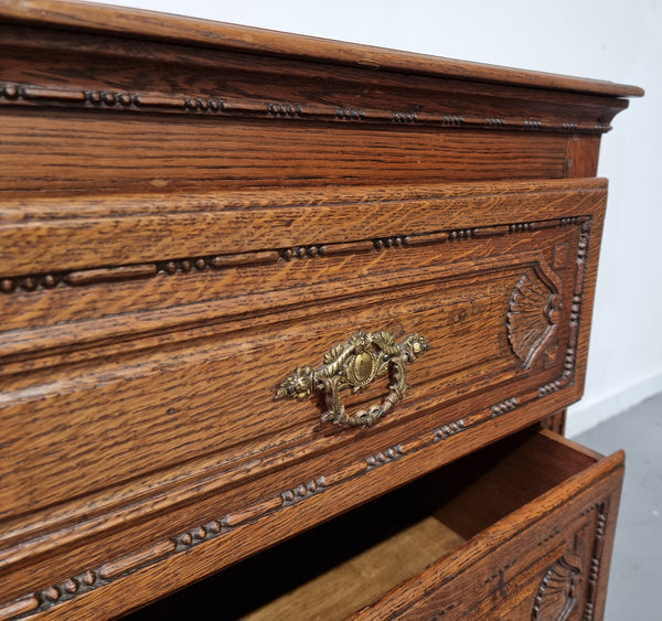 Early 19th Century French Oak chest of three drawers. It has beautiful handles and carvings. It is in good original detailed condition.