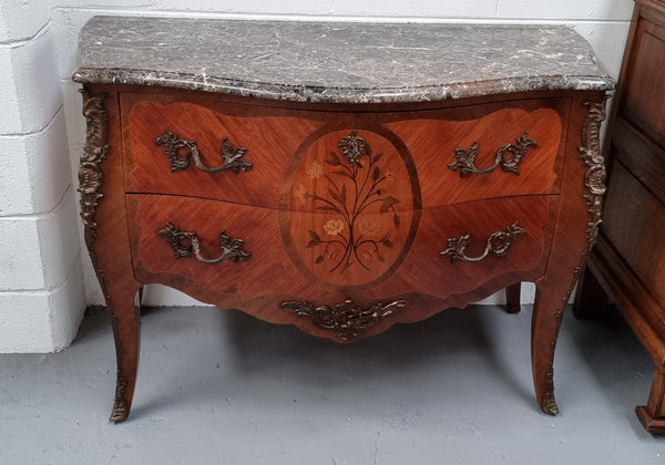 Beautiful French walnut Louis XV style two drawer commode. With a lovely floral marquetry inlaid design and marble top. It is in good original detailed condition.
