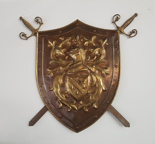 An Antique Embossed Shield with Swords
