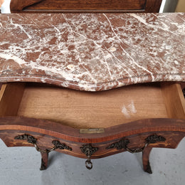 Antique French Louis XV style compact three drawer marble top commode with marquetry inlay and ormolu mounts. Sourced from France and in good original detailed condition.