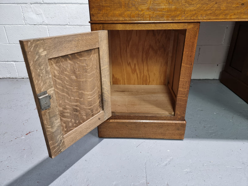 Amazing American Oak full partners leather top desk. Plenty of storage space with nine drawers on one side and two cupboards of the oppsite side. It is in good restored condition and has a new leather and gold tooled inset top.