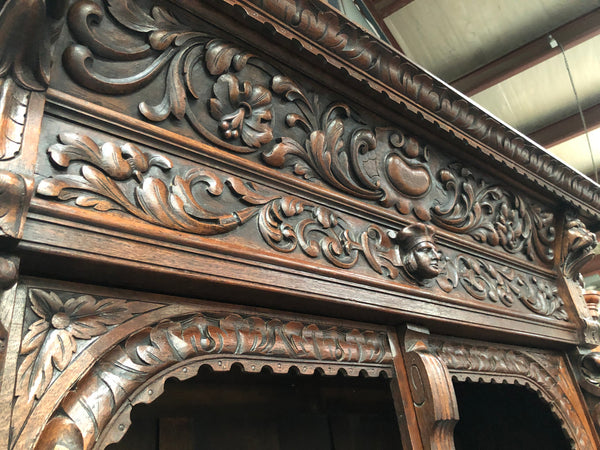 Amazing dark Oak heavily carved Gothic style bookcase with lovely details and adjustable shelves in good original detailed condition. The doors currently have no glass which can easily be added or be left  with open shelves.