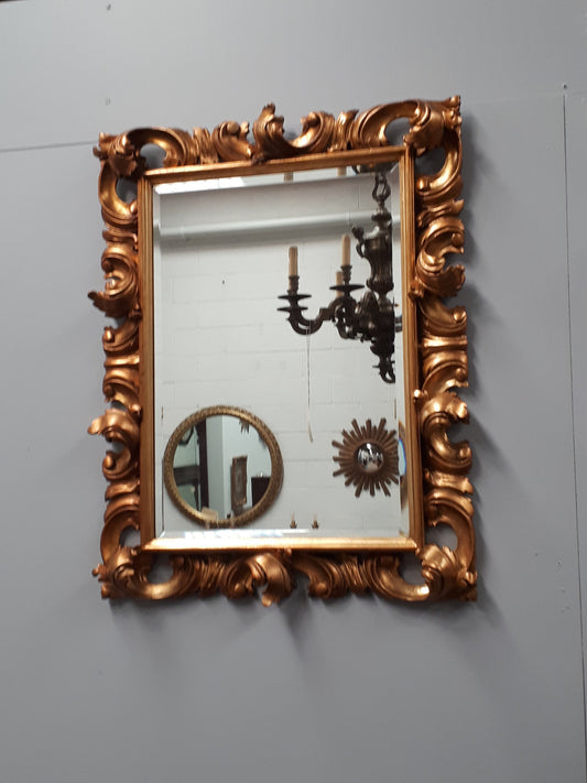 Early 20th Century French Rococo style gilt bevelled wall mirror. It has been sourced from France and is in good original condition. Circa 1920
