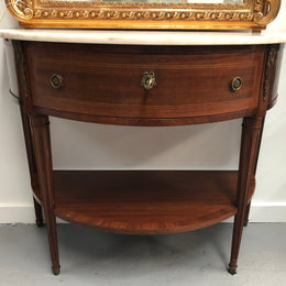 French marble top half round console table. It has beautiful marquetry inlay and ormolu mounts with a single drawer. In good original condition.