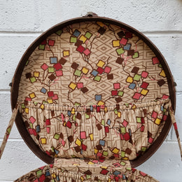 Charming solid leather hatbox with patterned fabric interior and two interior pockets. Interior stamp is for The Mutual Store Melbourne. Bears paper stamps for P&O Cruise Passenger” & “Peninsular  the top and D.M.F. in gold near the handle. Circa: Early 1900’s. 43 cm across and H:21 cm the lid.
