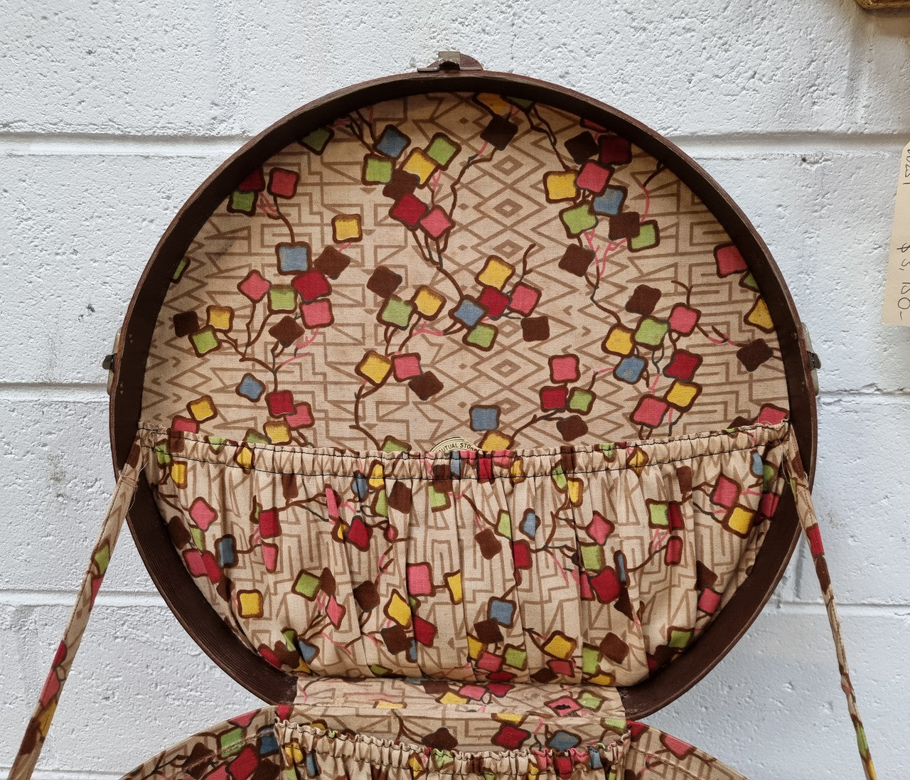 Charming solid leather hatbox with patterned fabric interior and two interior pockets. Interior stamp is for The Mutual Store Melbourne. Bears paper stamps for P&O Cruise Passenger” & “Peninsular  the top and D.M.F. in gold near the handle. Circa: Early 1900’s. 43 cm across and H:21 cm the lid.