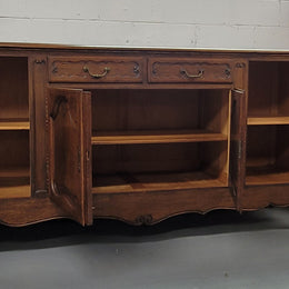 Louis XV style French Oak sideboard consisting of four doors and two drawers. It is in good restored condition.