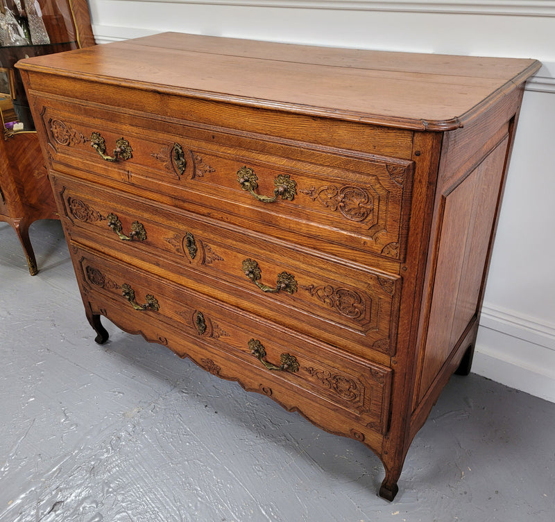 French Louis 15th style large three drawer chest featuring carved drawers. It has been sourced from France and is in good original detailed condition.