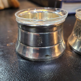 Pair antique silver salt cellars with liners. Stamped “800” 80g. 4.5cm Diam & 3cm Height. In good condition please view photos as they help form part of the description.