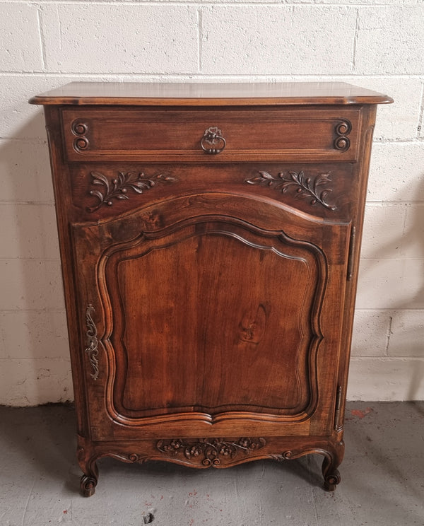 Louis 15th style walnut cupboard consisting of one drawer and two shelves. A pleasing unit with charming carvings. Circa: 1920's. In good original detailed condition.