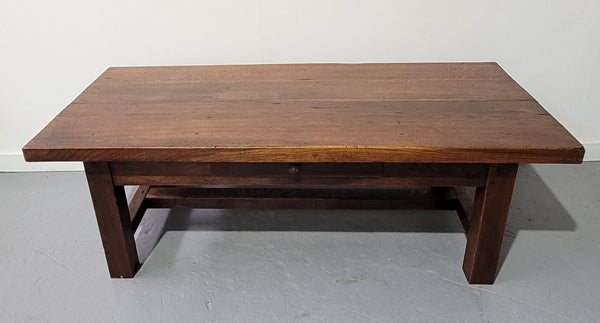 French Farmhouse style heavy Oak coffee table featuring a single drawer. In good original detailed condition.