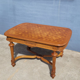 Beautiful carved French Oak dining table with a parquetry top and six matching upholstered chairs. All in good original detailed condition.