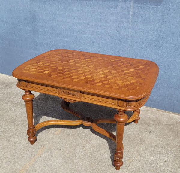 Beautiful carved French Oak dining table with a parquetry top and six matching upholstered chairs. All in good original detailed condition.