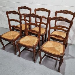 Lovely set of six French oak rush seated provincial dining chairs. They have been sourced from France and are in good detailed condition.