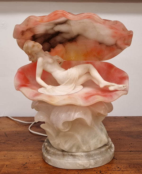 A superb original hand carved Art Deco lamp. Alabaster and marble sculpture of a nude woman inside a clam shell. Italian, inscription to base. Circa 1920's. Subtle colouring to clam shell for a sunset effect. This is a world class example of a true Art Deco sculpture lamp. It is in good original detailed condition, please view photos as they help form part of the description.