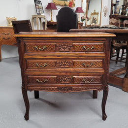 Rustic Louis XV style Oak petite three drawer chest featuring attractive carvings. It has been sourced locally and it is in good original detailed condition.