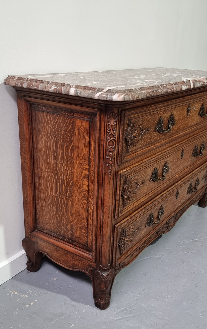 French Louis XV style three drawer Oak marble top commode. In good original detailed condition.