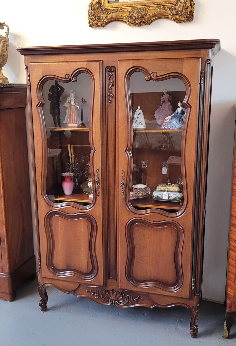 French Walnut Louis XV Style two half glass, door bookcase with three adjustable shelves. Sourced from France and in good original detailed condition.