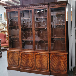 Georgian style Breakfront Flame Mahogany four door bookcase. A very impressive piece with plenty of storage and is of pleasing narrow proportions. It has been sourced locally and is in good original detailed condition.